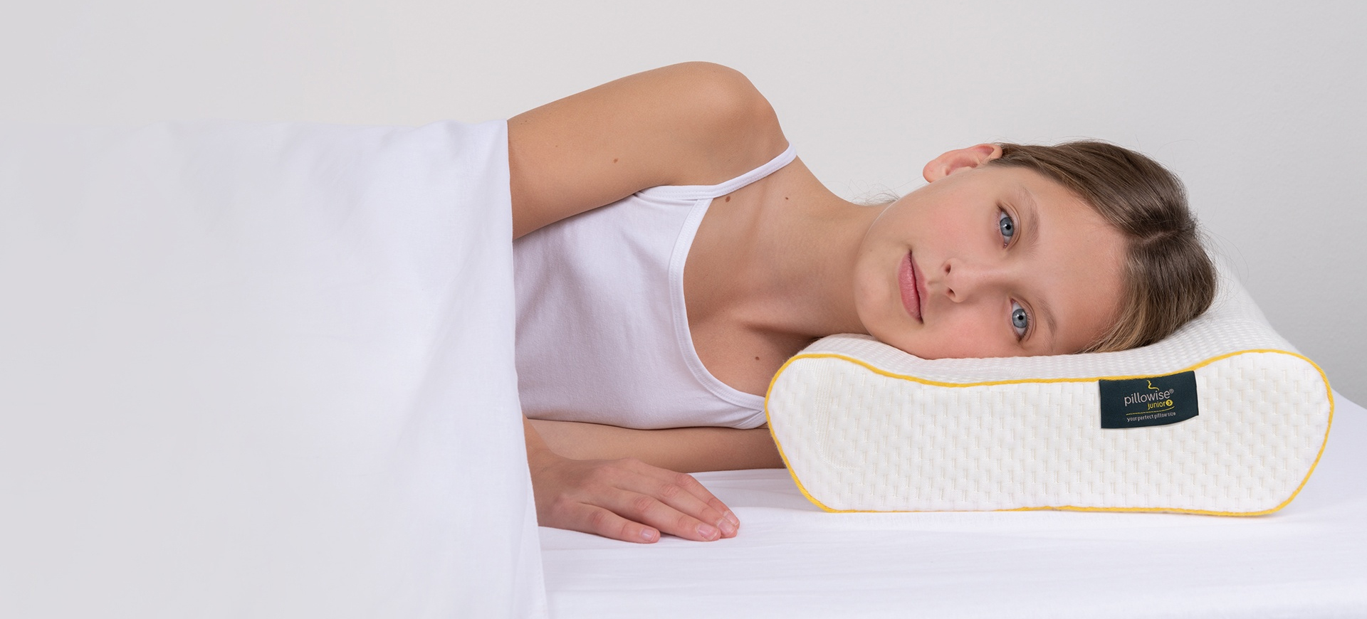 Child sleeping on a Pillowise Junior ergonomic pillow