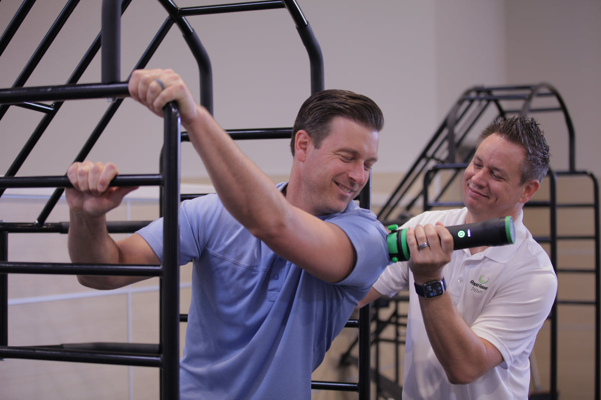 Therapist applying Rapid Release vibration therapy to a client in clinic